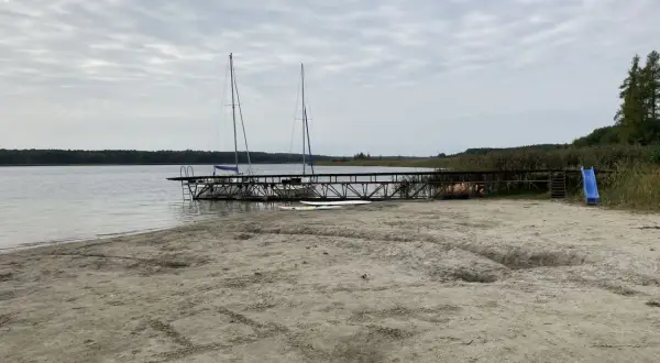 Plaża nad jeziorem powidzkim z pomostem, dwoma żaglówkami i zjeżdżalnią. Idealne miejsce na wodne atrakcje.