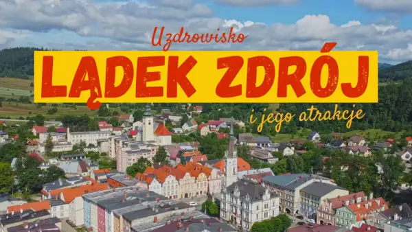 Uzdrowisko Lądek-Zdrój i jego atrakcje. Widok z lotu ptaka na urokliwe miasteczko z kolorowymi kamienicami i zielonymi wzgórzami w tle.