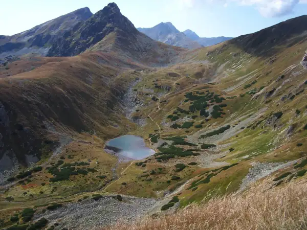 Malownicze Tatry oferują wspaniałe atrakcje. Widok na górskie jezioro i strome zbocza zachwyca.